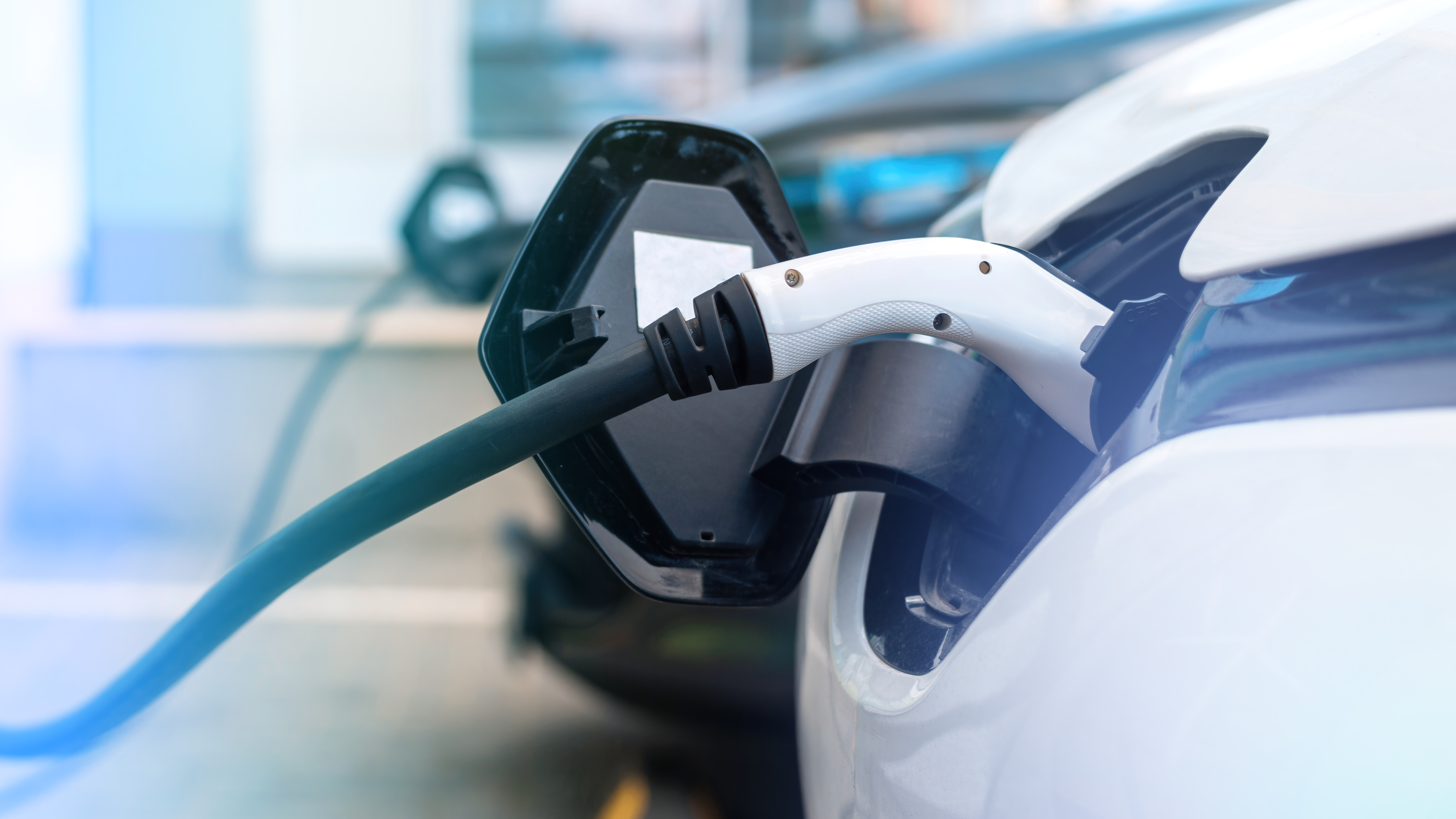 Two EVs charging at a high-power freeway charging hub in Texas